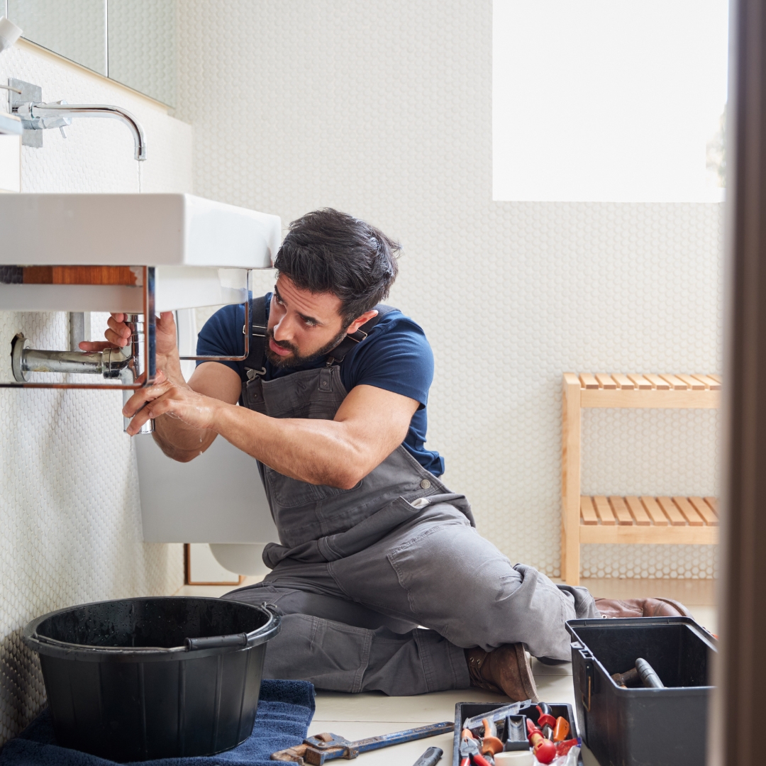 Local plumber working in a Kingston home